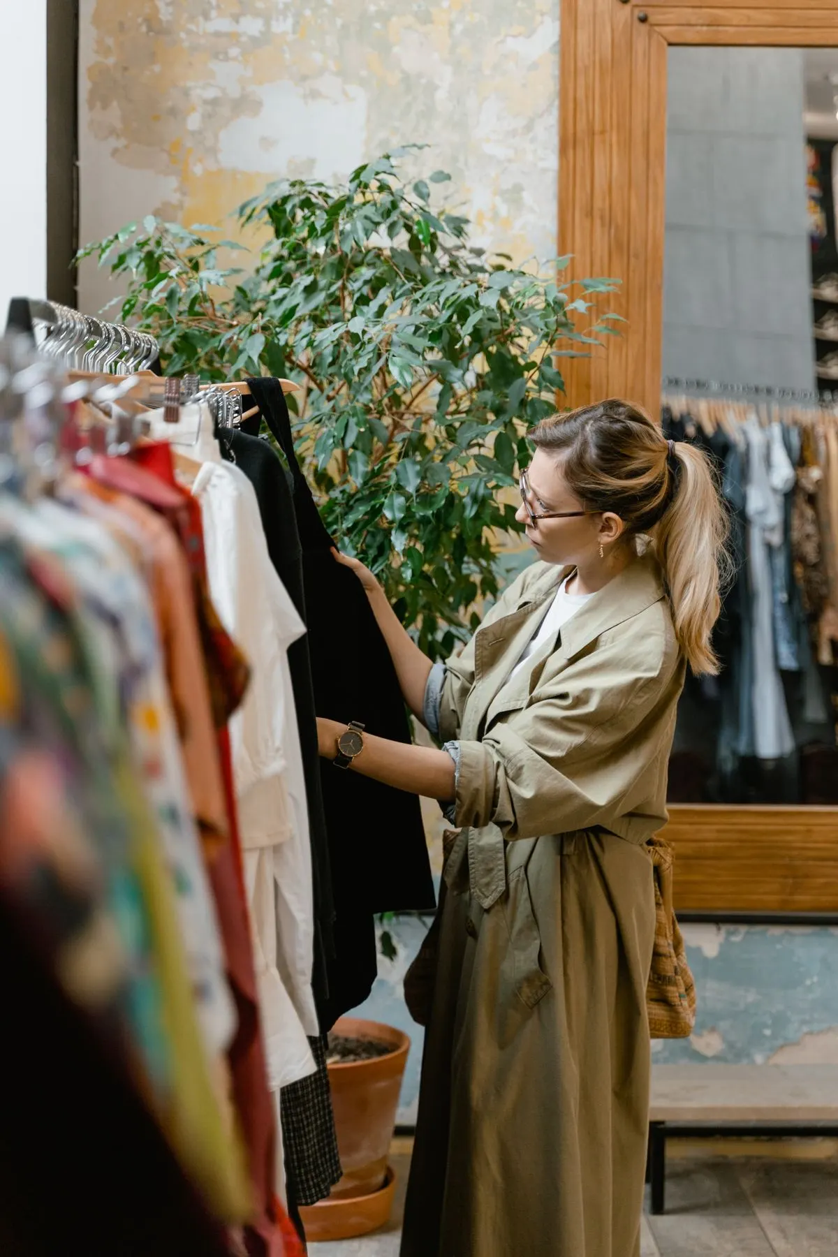 Shopper looking through a rack of clothes in a small boutique